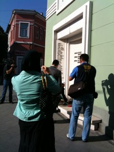 Laying flowers at a memorial for young people who died when a shell hit the place where they used to hang out in the evenings.